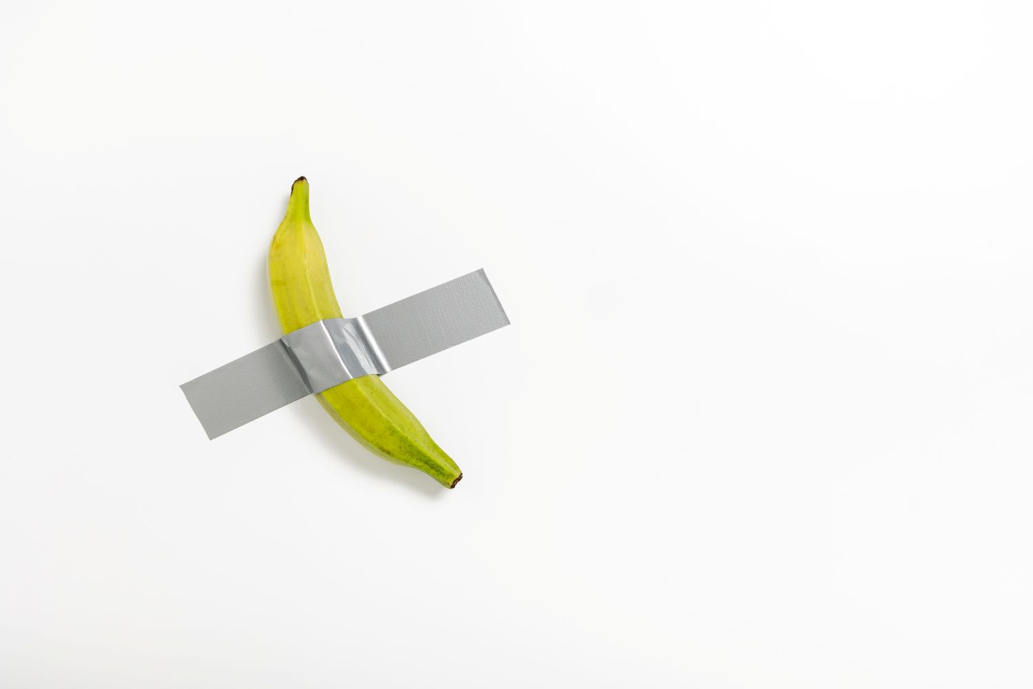 Banana-shaped wall-mount tape dispenser